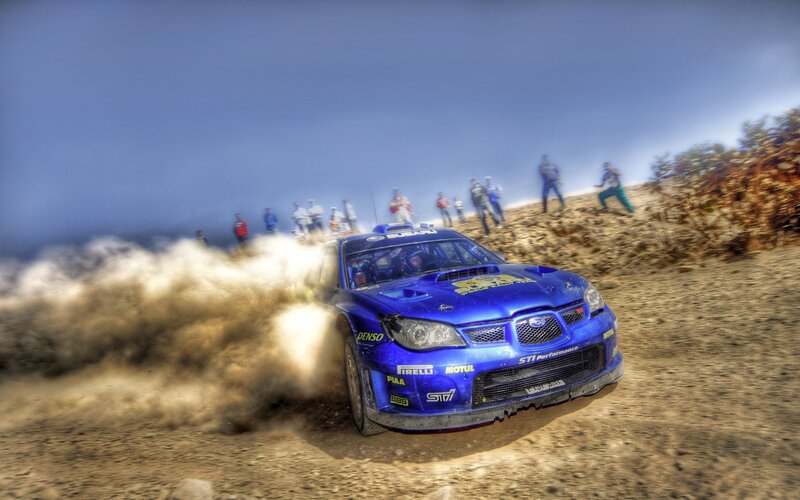 Blue rally car on dirt track