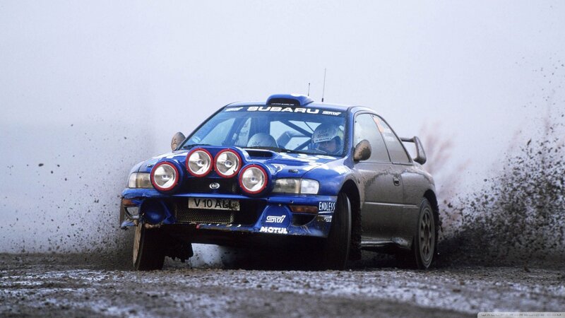 Blue rally car on dirt track