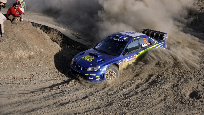 Blue rally car on dirt track