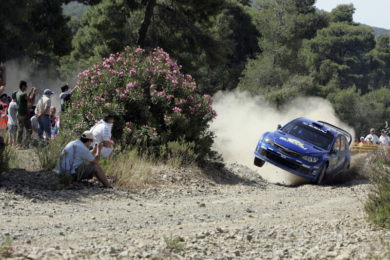 Blue rally car on dirt track