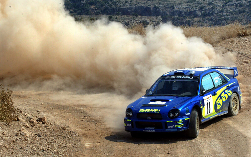 Blue rally car on dirt track