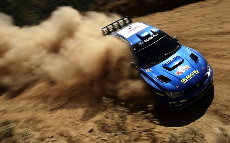 Blue rally car on dirt track