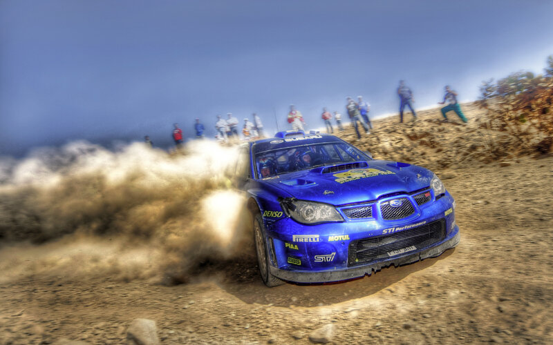 Blue rally car on dirt track