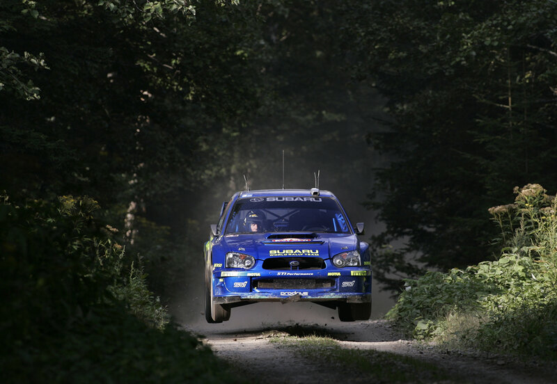 Blue rally car on forest road