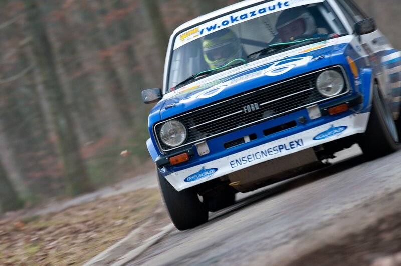 Blue rally car on forest road
