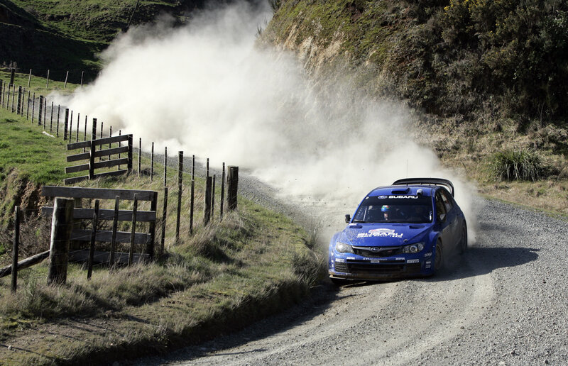 Blue rally car on gravel road