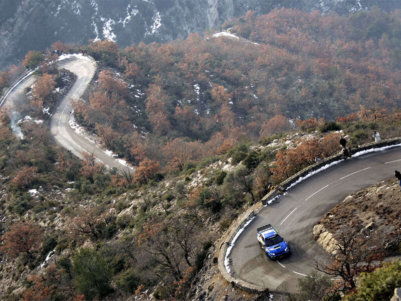 Blue rally car on mountain road