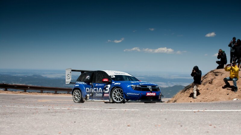 Blue rally car on mountain road