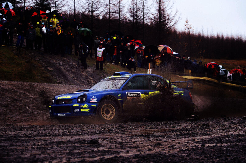 Blue rally car on muddy track