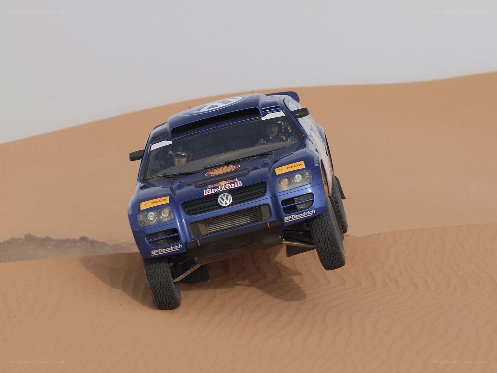 Blue rally car on sand dune