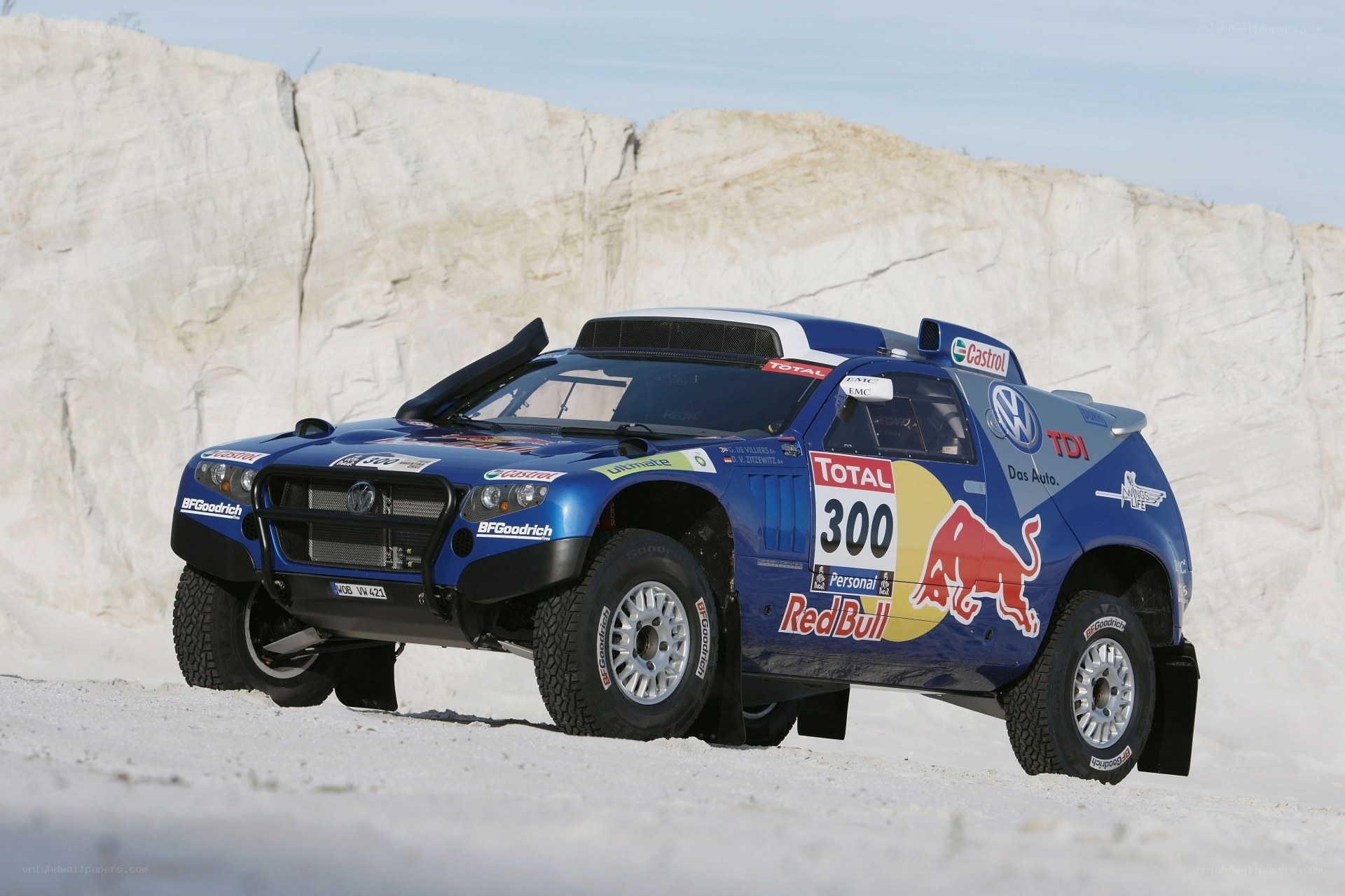 blue rally car on sand
