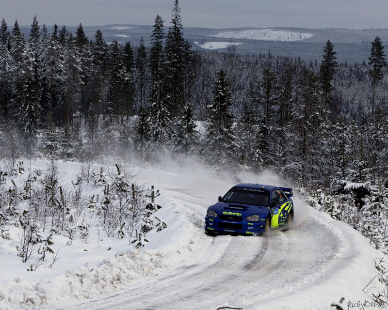Blue rally car on snowy road