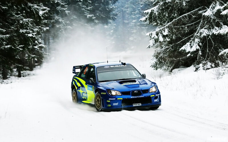 Blue rally car on snowy road