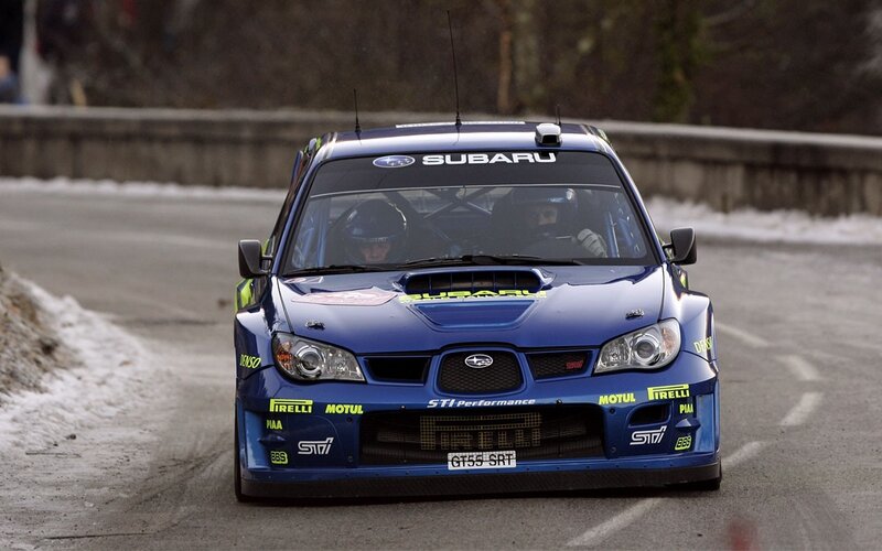 blue rally car on snowy road
