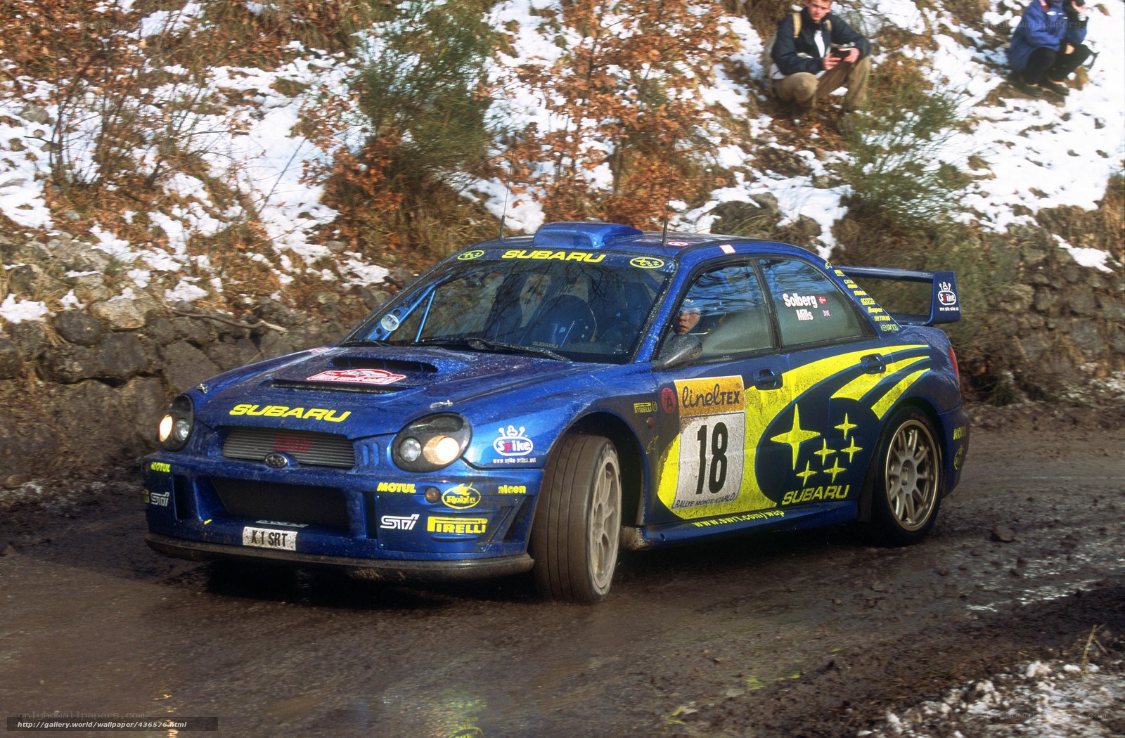 blue rally car on snowy road