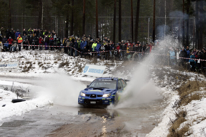 Blue rally car on snowy track