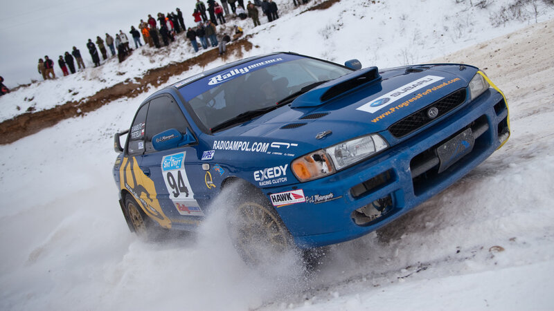 Blue rally car on snowy track