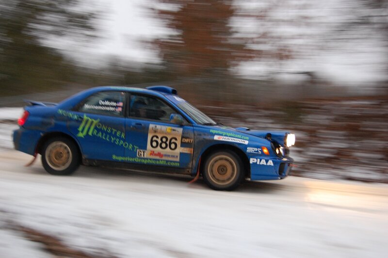 Blue rally car on snowy track