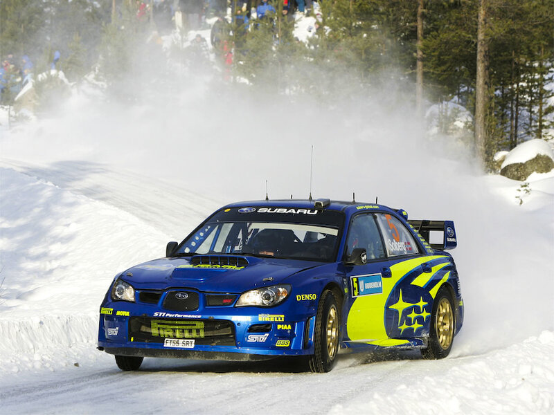 Blue rally car on snowy track