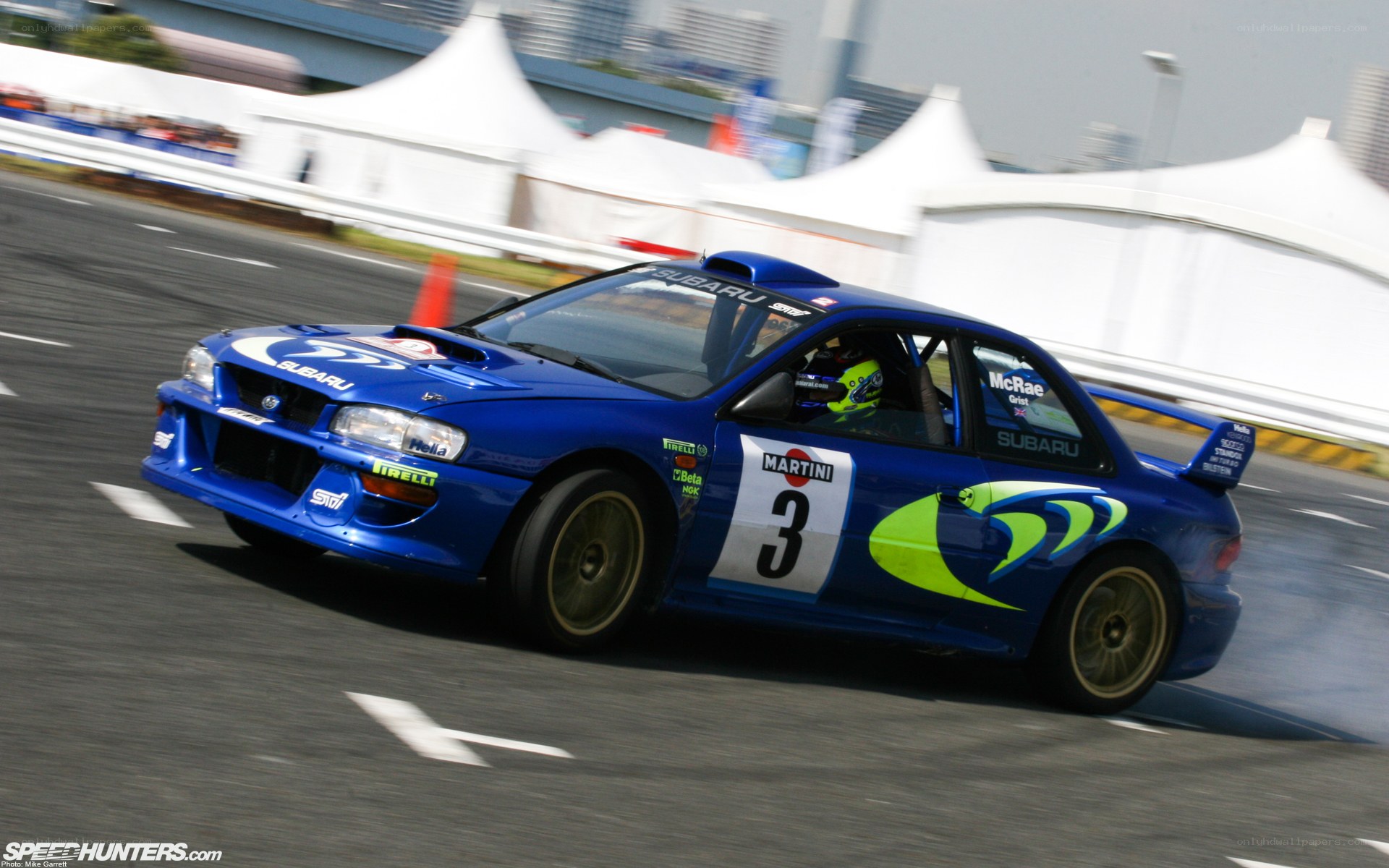 blue rally car on track