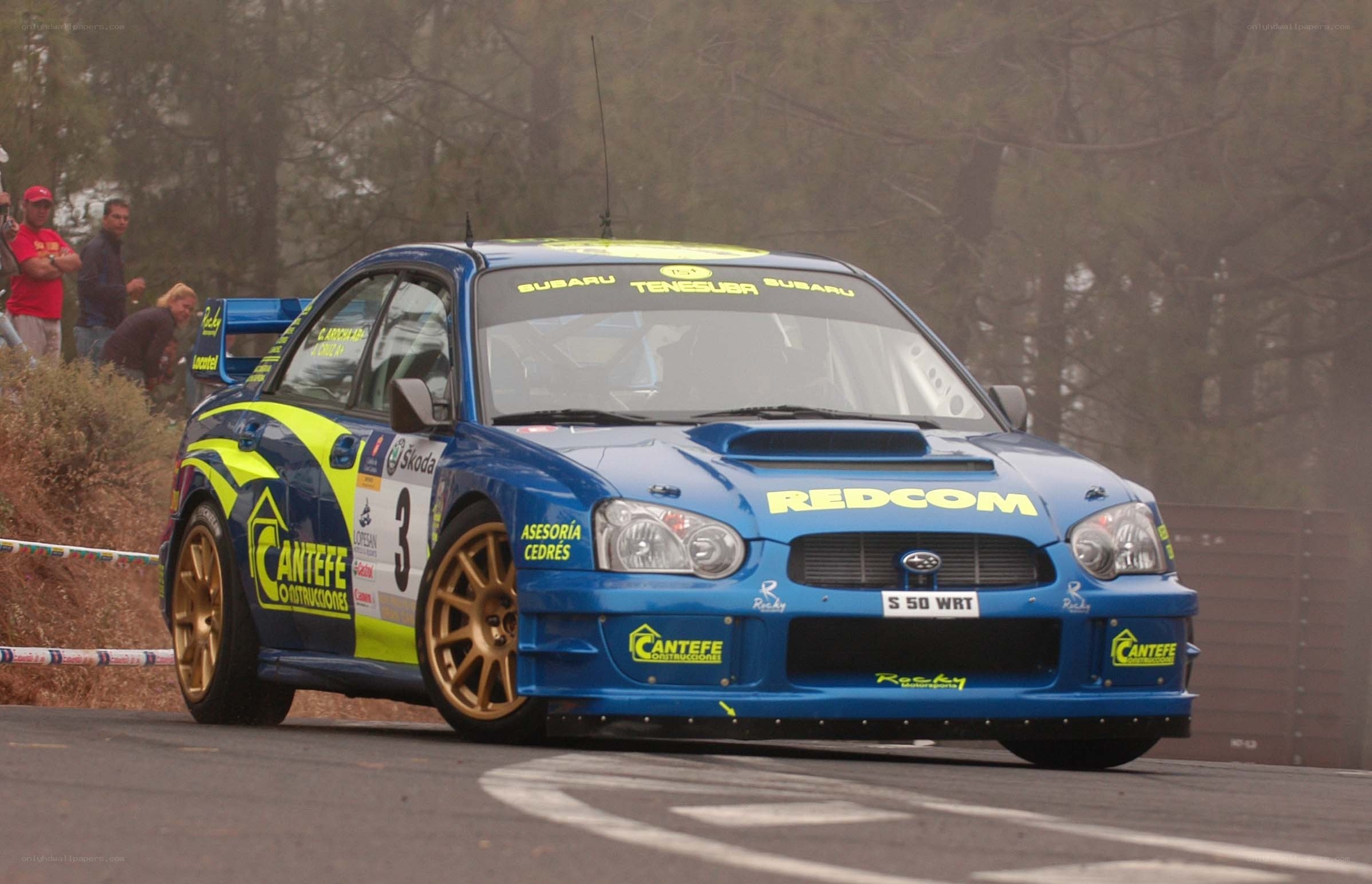 blue rally car on track