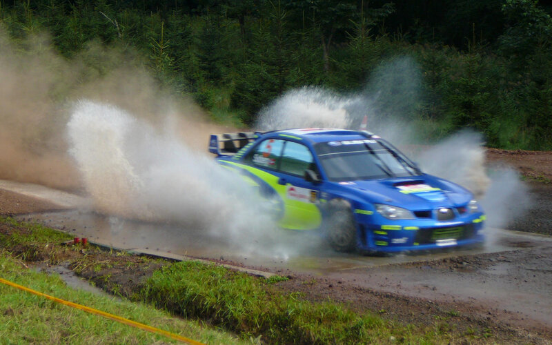Blue rally car on wet track