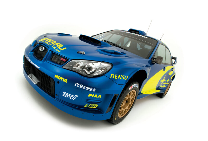 blue rally car with sponsor logos