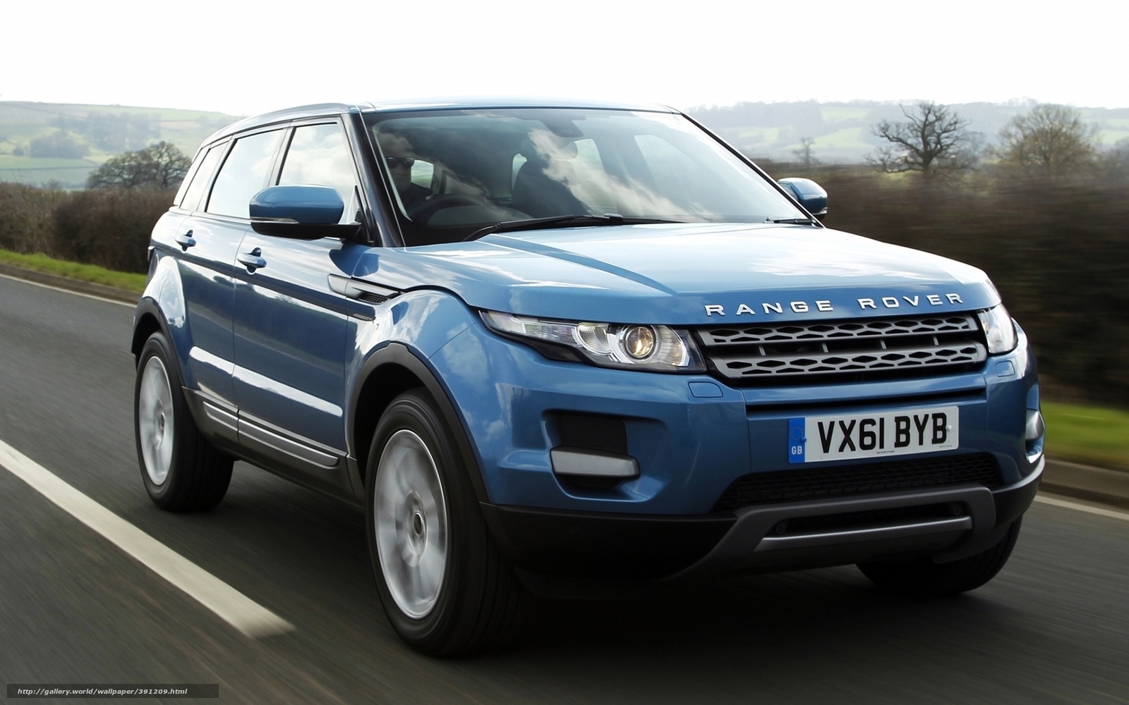 Blue Range Rover driving on road