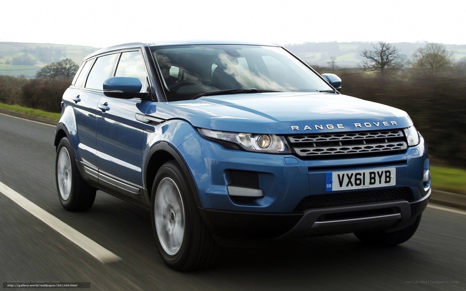 Blue Range Rover driving on road