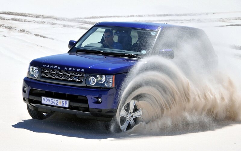 Blue Range Rover on sand
