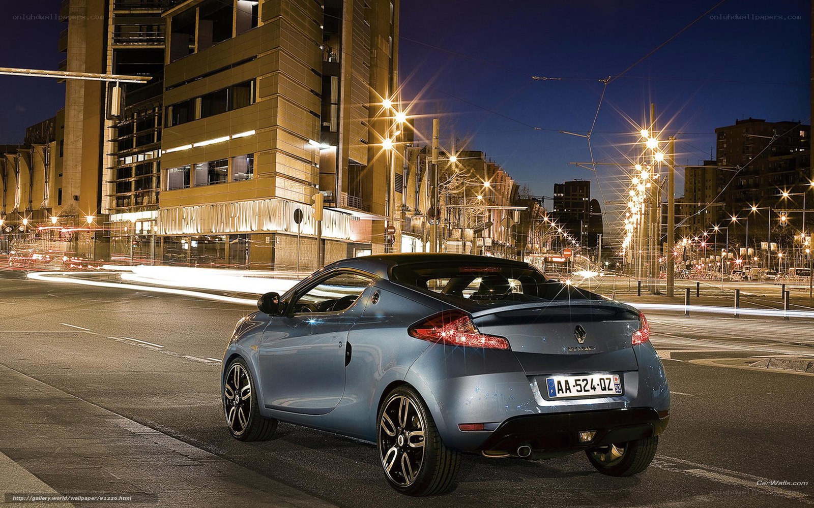 Blue Renault Clio in city at night