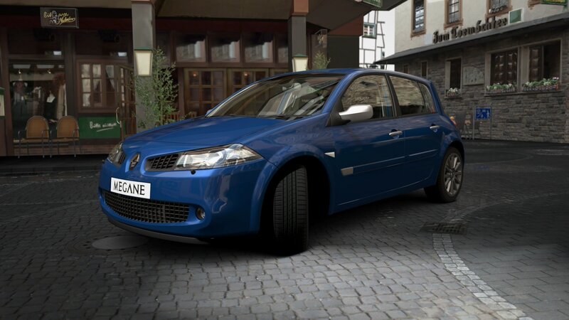 Blue Renault Mégane on cobblestone street