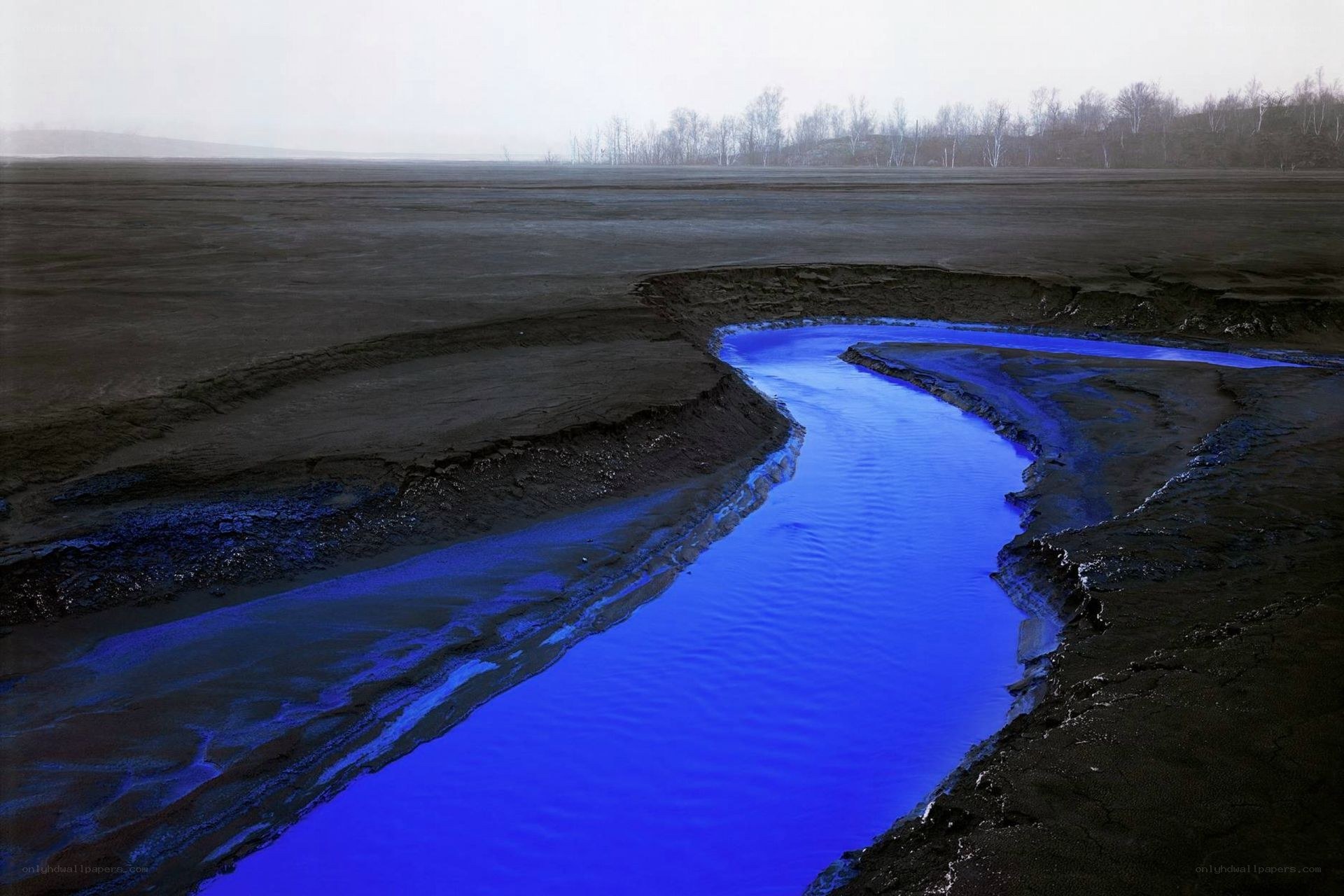 Blue river in barren landscape