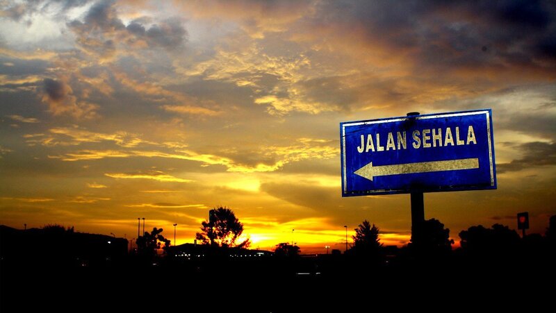 Blue Road Sign at Sunset