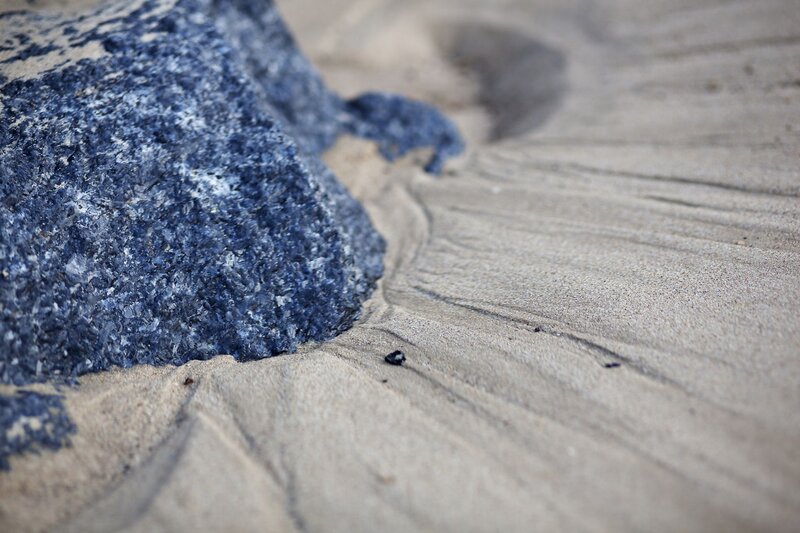 blue rock on sandy beach