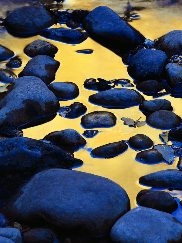 Blue rocks in golden water