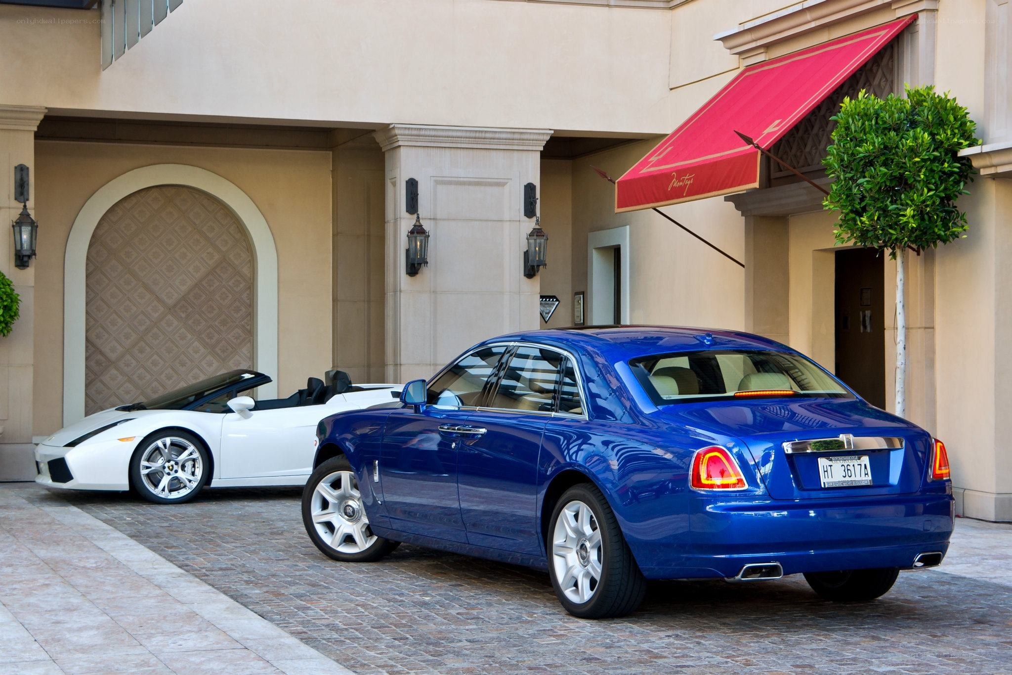 Blue Rolls-Royce and white Lamborghini
