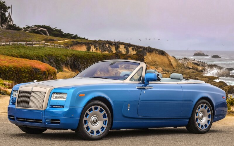 Blue Rolls-Royce convertible by coast