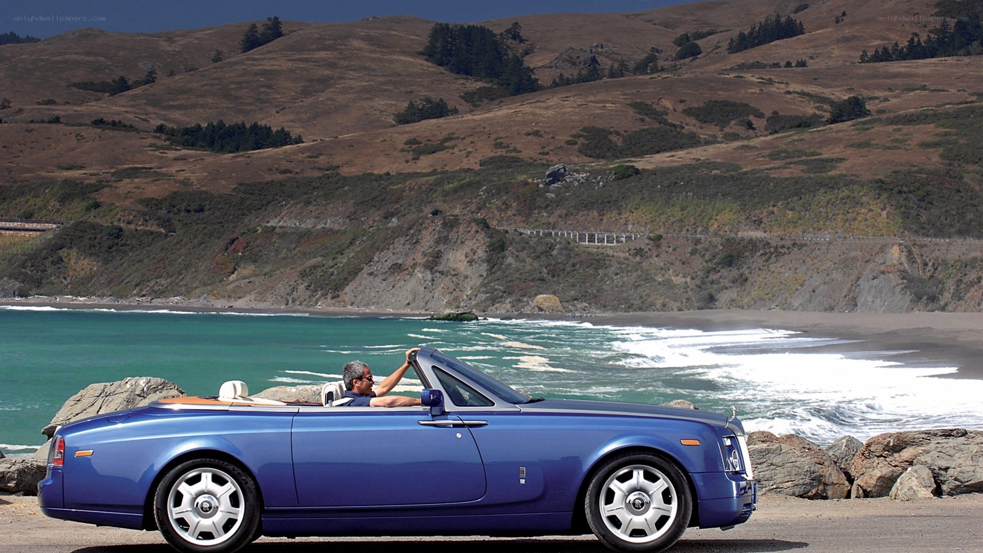 Blue Rolls-Royce convertible on coast
