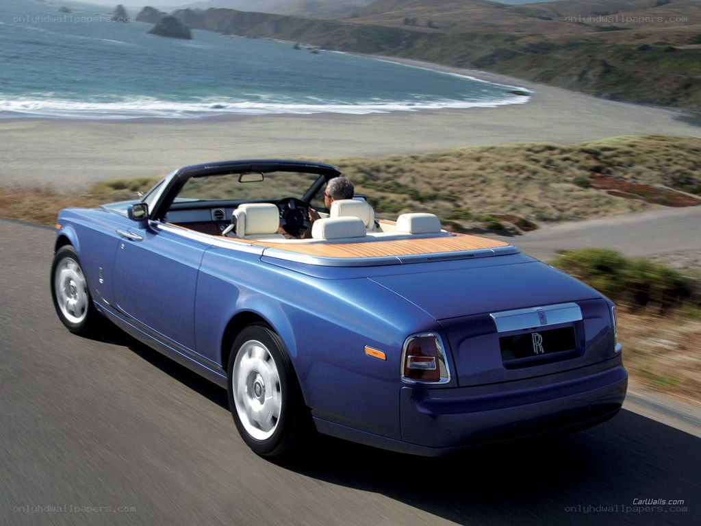 Blue Rolls-Royce convertible on coast