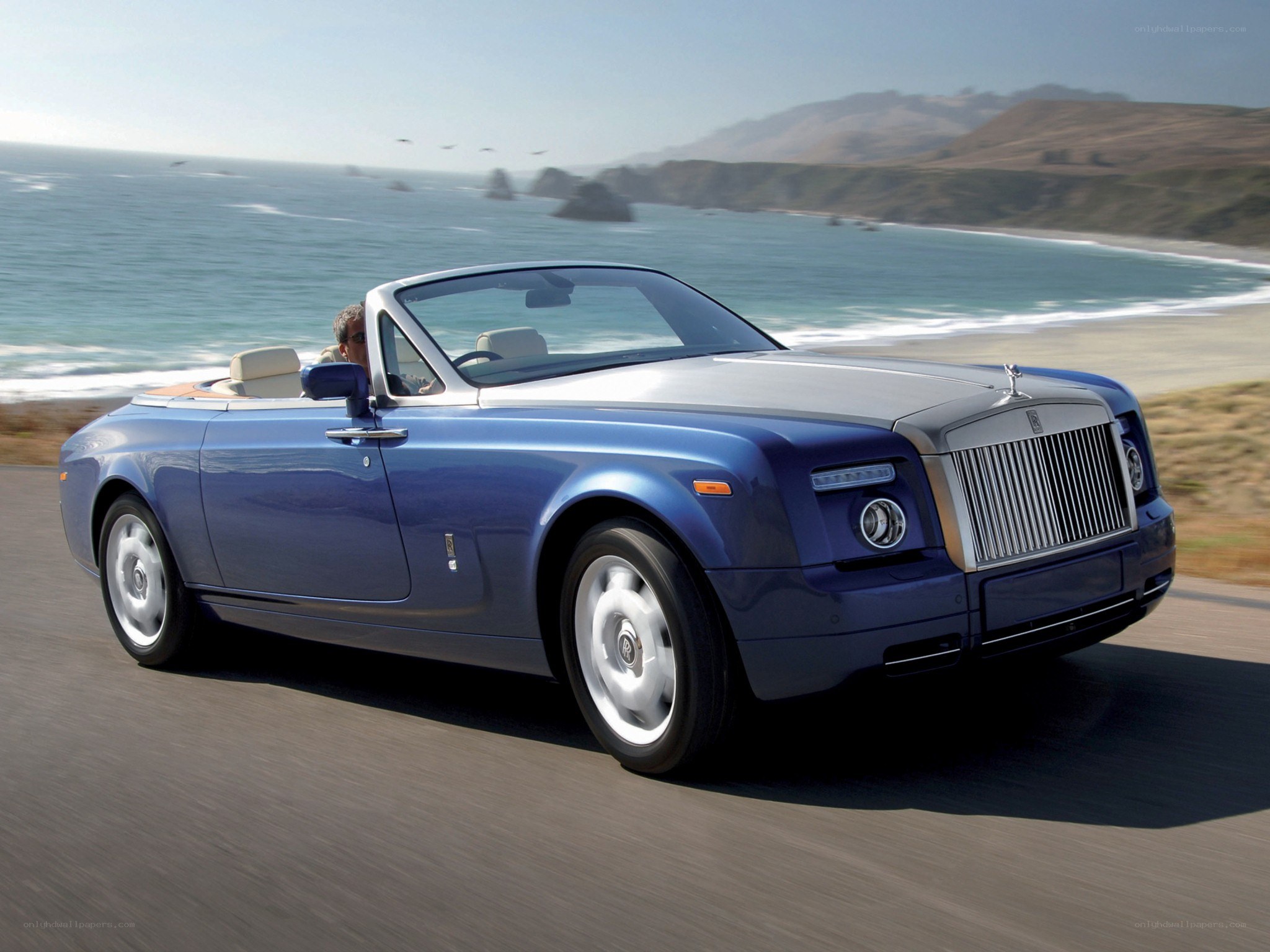 Blue Rolls-Royce convertible on coast