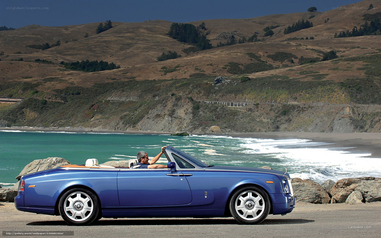 Blue Rolls-Royce convertible on coast