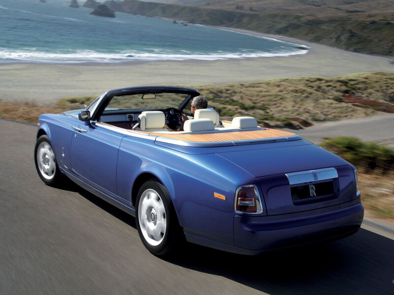 Blue Rolls-Royce convertible on coastal road
