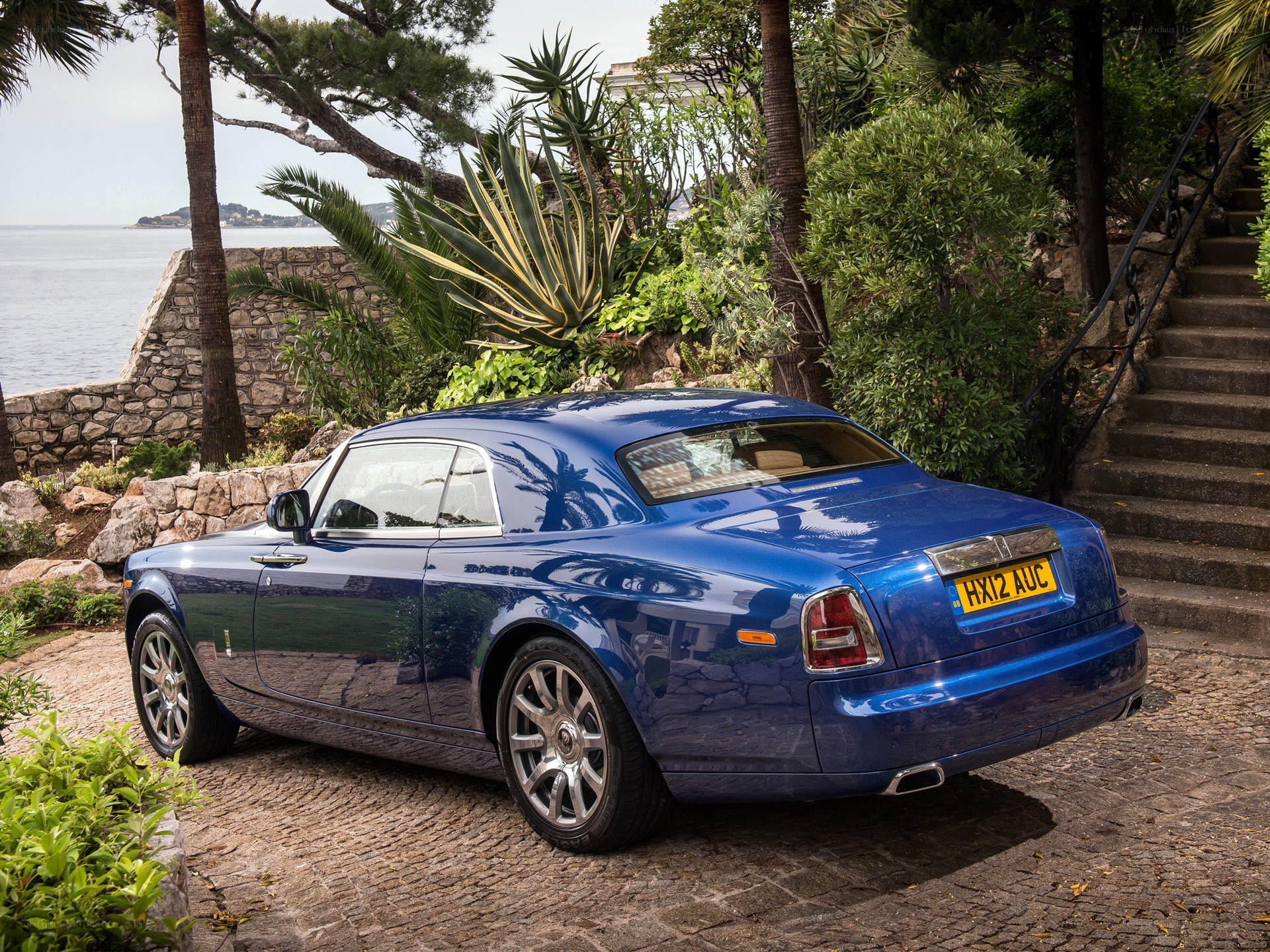 Blue Rolls-Royce on a coastal path