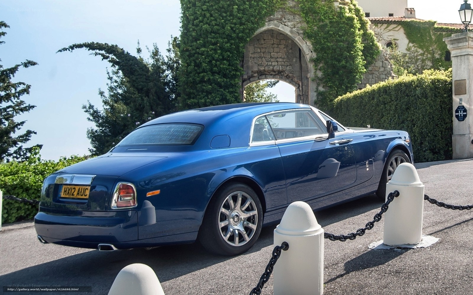 Blue Rolls-Royce parked outside