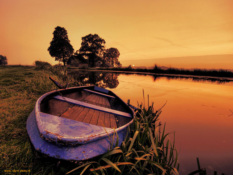 Blue Rowboat on Riverbank