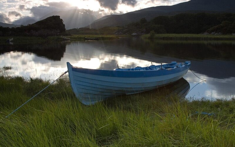 Blue Rowboat on Shore — Mountains