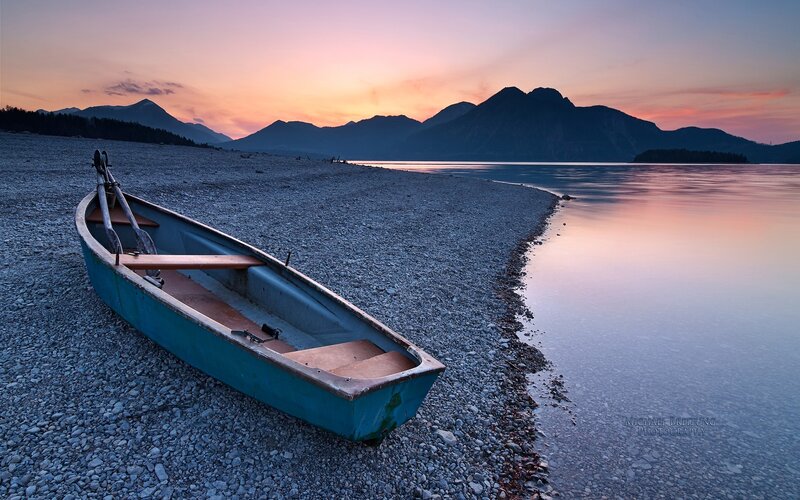 Blue Rowboat on Shore — Serene, Sunset, Photograph, Mountains, Lake, Orange