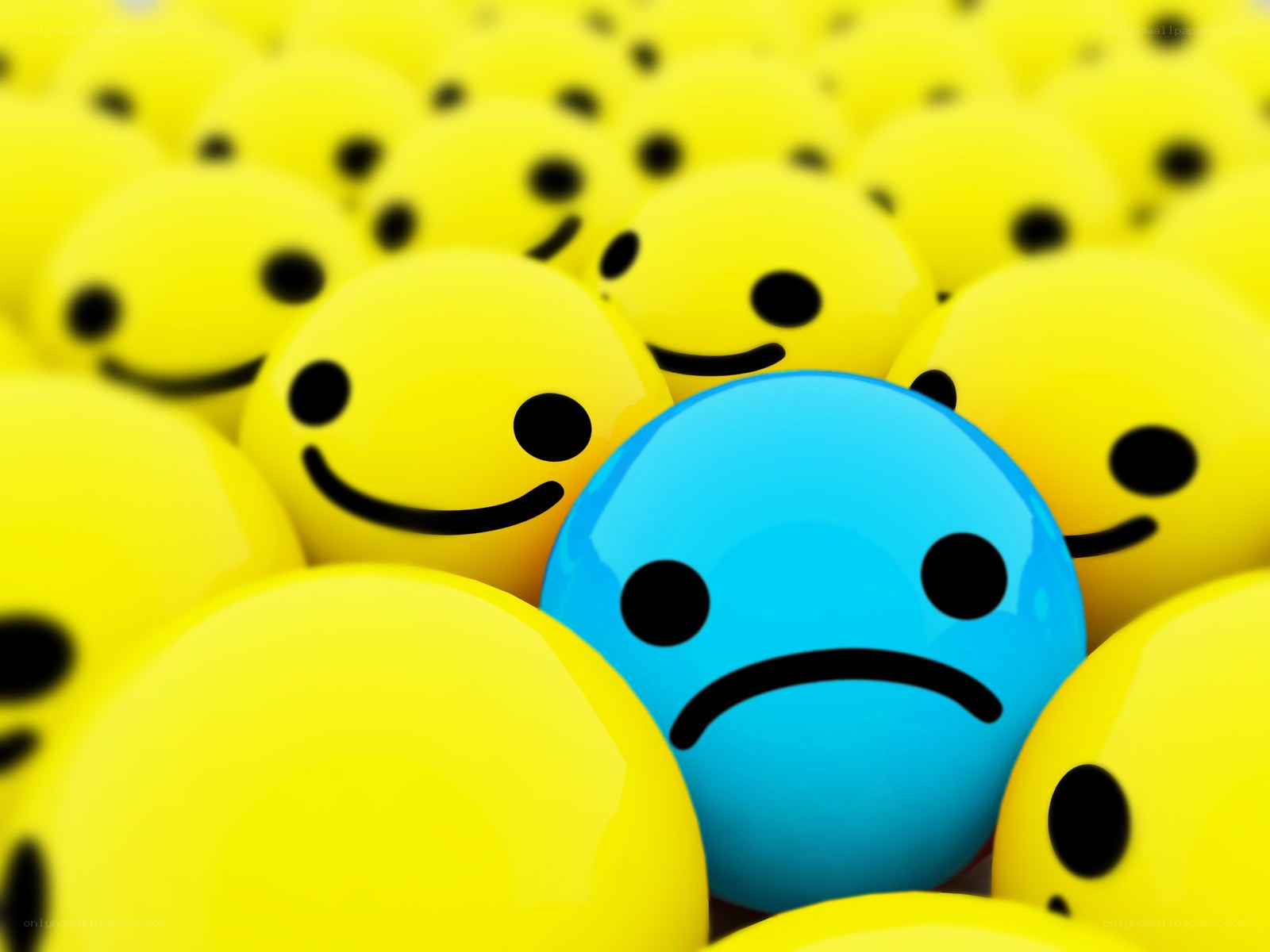 blue sad face among yellow smiles