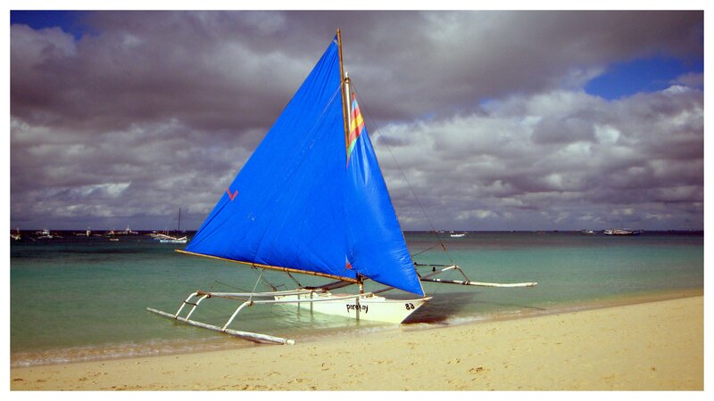 Blue-sailed Outrigger Boat